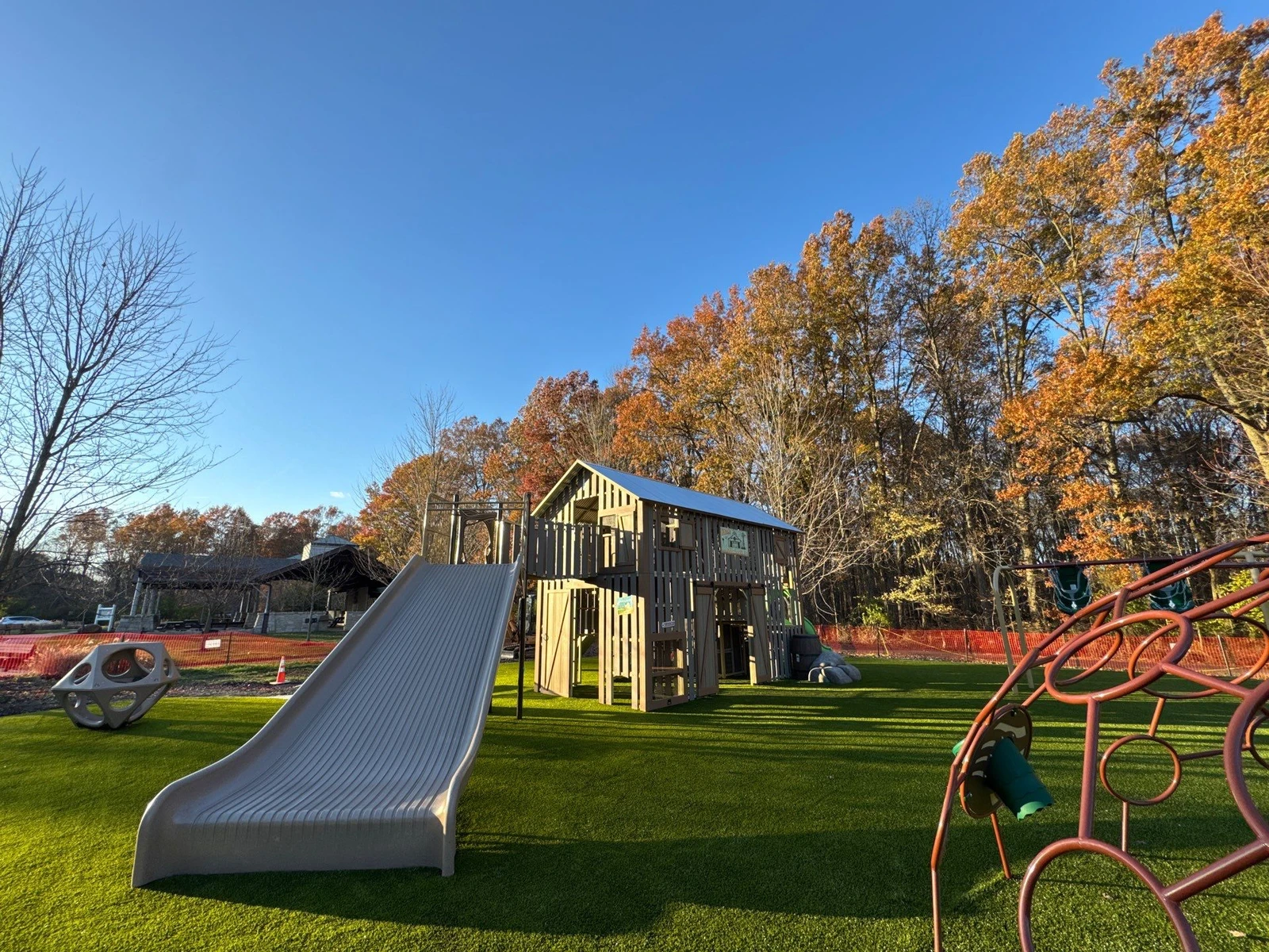 Playground Grass Ultra artificial turf surrounds a wooden play structure with slide and climbing equipment at McNamara Park, Galena OH.